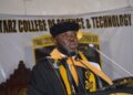 Starz University founder Ambassador Latim Da-Thong delivers a speech in academic regalia during a commencement ceremony, supporting NCHE reforms in Liberia’s higher education sector.