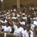 Hundreds of Liberian children raise UNICEF pamphlets at a youth gathering in Monrovia during Day of the African Child commemoration.