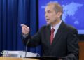 U.S. Ambassador addressing immigration concerns during a press briefing, calling for economic reforms in Liberia to curb visa overstays.