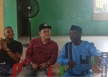 Community members and Vision Africa Mining representatives discuss proposed black sand project in Marshall City, Liberia