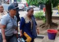 Mary Broh, escorted by security officers, arrives at court following her arrest in the Saudi rice corruption scandal after police breached protocol by raiding former President Ellen Johnson Sirleaf’s residence.