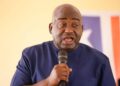 Rep. Musa Hassan Bility speaks into a microphone during a press appearance in Monrovia, calling for a Legislature audit and criticizing President Boakai over the Koffa arson trial.