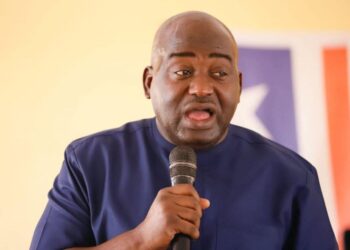 Rep. Musa Hassan Bility speaks into a microphone during a press appearance in Monrovia, calling for a Legislature audit and criticizing President Boakai over the Koffa arson trial.