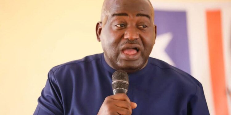 Rep. Musa Hassan Bility speaks into a microphone during a press appearance in Monrovia, calling for a Legislature audit and criticizing President Boakai over the Koffa arson trial.