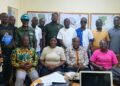 NBC officials and representatives from government institutions pose in Maryland County during a compliance review of MOPP and CRC concessions.