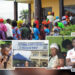 Collage showing chaos and frustration at Liberia’s National Identification Registry centers. Citizens are seen in long queues, arguing with staff, and waiting under tents. A central image shows the NIR office sign, while others feature people looking exhausted, stressed, or pleading. An official wearing an NIR vest appears in one frame. The overall scene highlights overcrowding, disorder, and citizen distress over the ID registration process.