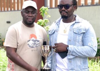 PANASA President Adekoyejo Adegbesan and NASAL President Lester Dgian Morris pose with a Scrabble trophy during a preparatory visit for the 2026 Pan African Championship in Liberia.