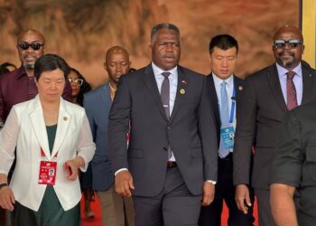PPCC Executive Director Bodger Scott Johnson walks with Vice President Jeremiah Koung and officials in China during a vendor inspection visit, raising conflict of interest concerns.