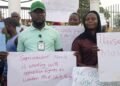 Unity Party supporters in Bong County hold protest signs at the Gbarnga Administration Building demanding the resignation of Superintendent Hawa Norris for alleged betrayal and marginalization