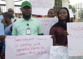 Unity Party supporters in Bong County hold protest signs at the Gbarnga Administration Building demanding the resignation of Superintendent Hawa Norris for alleged betrayal and marginalization