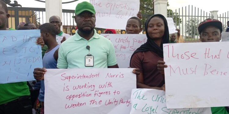 Unity Party supporters in Bong County hold protest signs at the Gbarnga Administration Building demanding the resignation of Superintendent Hawa Norris for alleged betrayal and marginalization
