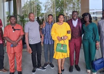 West African journalists, including Liberia’s Willie Tokpah, pose outside QNET’s Malaysian headquarters during a media familiarization tour aimed at combating misinformation.