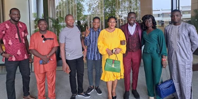 West African journalists, including Liberia’s Willie Tokpah, pose outside QNET’s Malaysian headquarters during a media familiarization tour aimed at combating misinformation.