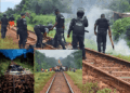 Liberia National Police officers assess damage and clear debris from the ArcelorMittal railway after sabotage in Grand Bassa County.