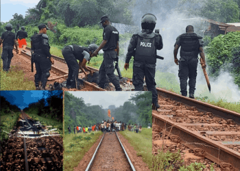 Liberia National Police officers assess damage and clear debris from the ArcelorMittal railway after sabotage in Grand Bassa County.