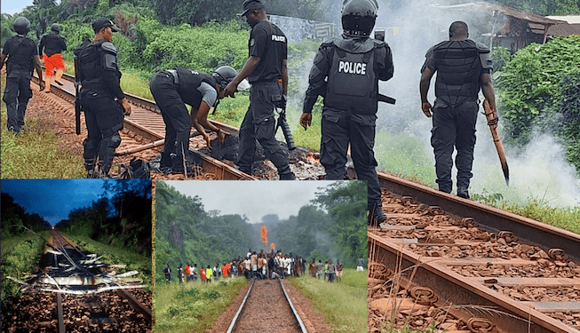 Liberia National Police officers assess damage and clear debris from the ArcelorMittal railway after sabotage in Grand Bassa County.