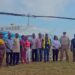 Officials from the Liberia Airport Authority, Samaritan’s Purse, and local authorities pose in front of a helicopter during the groundbreaking of the Sanniquellie Airstrip rehabilitation project in Nimba County.
