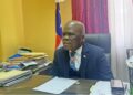 Senator Numene T.H. Bartekwa seated at his office in Monrovia, surrounded by legislative documents, calling for the termination of Atlantic Resources' logging concession