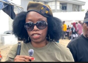 Veronica Mamie Doe speaks to the media wearing dark sunglasses and a military-style beret as controversy erupts over her public allegations against the Doe family.