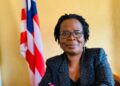 Attorney Victoria Duncan seated near Liberian flag, nominated as Resident Judge of the 13th Judicial Circuit by President Joseph Boakai.