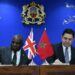 UK Foreign Secretary David Lammy and Moroccan Foreign Minister Nasser Bourita sign a joint communiqué in Rabat, seated at a desk with the UK and Moroccan flags displayed, under the Moroccan Ministry of Foreign Affairs emblem.
