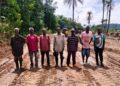 Local leaders and engineers stand on a newly cleared road section in Zota District, Bong County, marking progress on a six-kilometer community-led project.