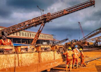 Liberian mine workers at ArcelorMittal Tokadeh site operating heavy equipment near the newly commissioned iron ore concentrator
