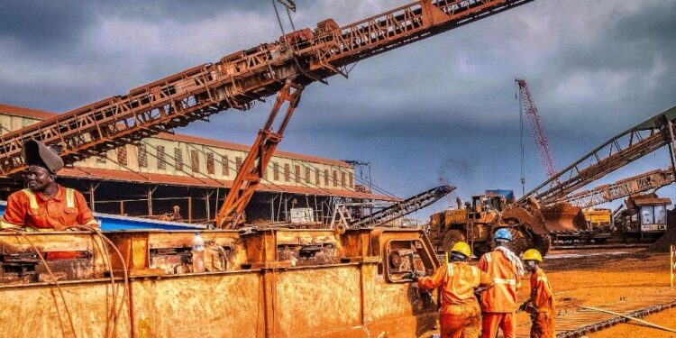Liberian mine workers at ArcelorMittal Tokadeh site operating heavy equipment near the newly commissioned iron ore concentrator