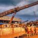 Liberian mine workers at ArcelorMittal Tokadeh site operating heavy equipment near the newly commissioned iron ore concentrator