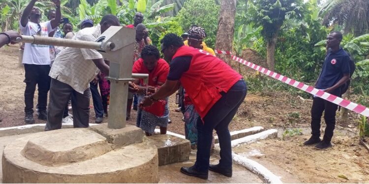 Liberia Red Cross staff dedicate a newly constructed hand pump in Sarwolor Town, Bong County, as community members celebrate access to clean water.