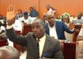 Liberian lawmakers raise hands during a legislative session at the Capitol as they review a bill seeking to reinstate oversight in county budget approvals.