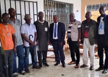 Liberian officials from the LRRRC and LIS pose with community leaders during the launch of the biometric registration for former Ivorian refugees.