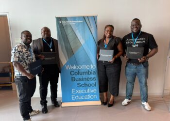 Four ArcelorMittal Liberia executives proudly display Columbia Business School certificates after completing the LEAD CONNECT High Impact Leadership Program