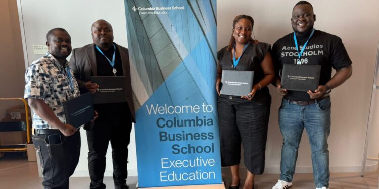Four ArcelorMittal Liberia executives proudly display Columbia Business School certificates after completing the LEAD CONNECT High Impact Leadership Program