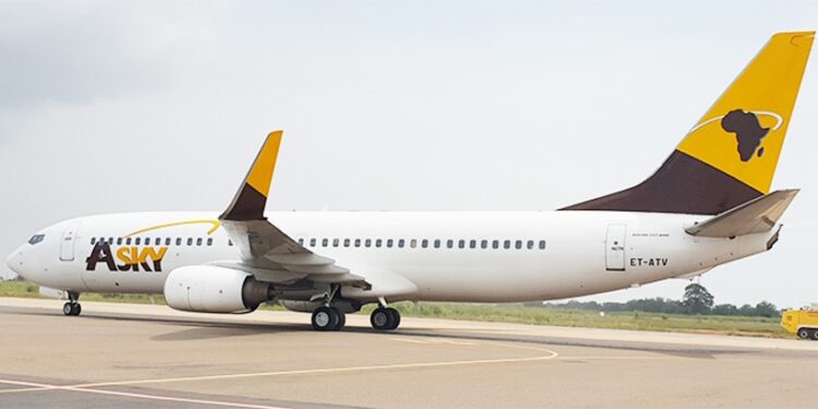 ASKY Airlines Boeing 737 aircraft taxiing on runway at Roberts International Airport in Liberia