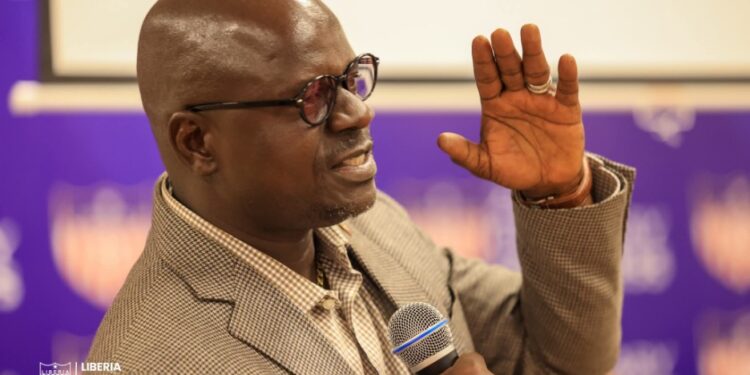 Deputy Sports Minister G. Andy Quamie speaks at CAF coaching course graduation, urging unity in Liberian football amid criticism of his past leadership role.