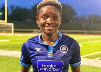 Liberian footballer Angeline Kieh wearing blue jersey after signing with Determine Girls for CAF qualifiers