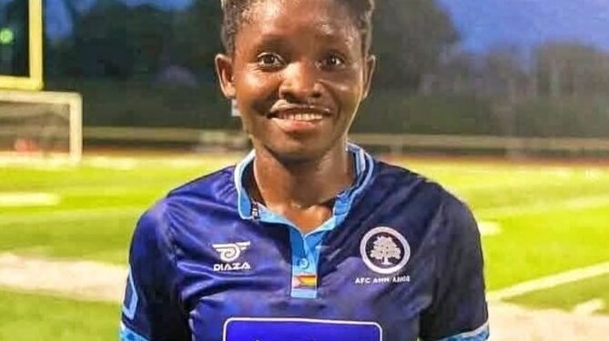 Liberian footballer Angeline Kieh wearing blue jersey after signing with Determine Girls for CAF qualifiers