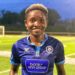Liberian footballer Angeline Kieh wearing blue jersey after signing with Determine Girls for CAF qualifiers