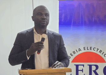 Atty. Kla-Edward Toomey II speaking at podium as Liberia ranks among top performers in AfDB’s 2024 Electricity Regulatory Index