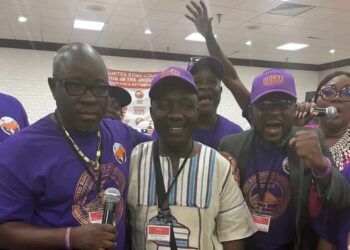 Bong County lawmakers Moye, Cole, and Kollie smile and embrace during reconciliation at the UBCAA diaspora convention in Kentucky