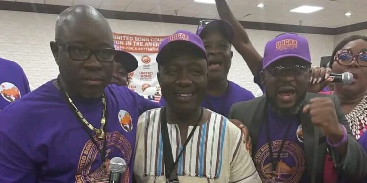 Bong County lawmakers Moye, Cole, and Kollie smile and embrace during reconciliation at the UBCAA diaspora convention in Kentucky