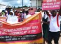 Protesters in Gbarnga march against the repeal of key sections of the 2018 Local Government Act holding banners and placards