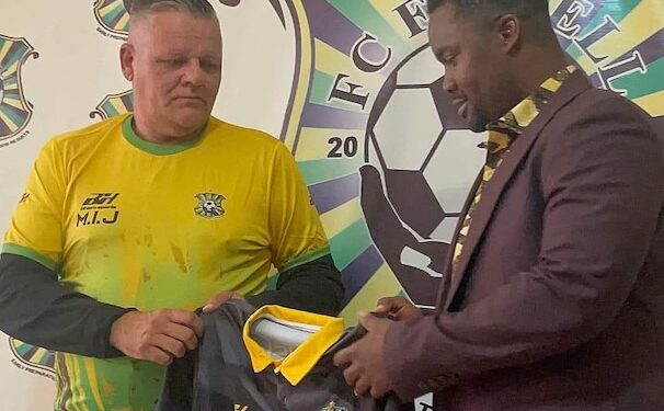 FC Fassell official presents club jersey to Belgian coach Ivan Minnaert during his unveiling ceremony in Monrovia before their contract dispute.