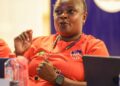 Zambian coach Florence Mwila participates in a CAF A Coaching Diploma session in Monrovia, Liberia, wearing a red training jersey with the Liberia Football Association logo.