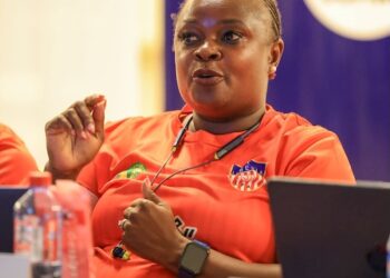 Zambian coach Florence Mwila participates in a CAF A Coaching Diploma session in Monrovia, Liberia, wearing a red training jersey with the Liberia Football Association logo.
