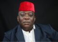 Montserrado County Rep. Bernard Blue Benson Jr. in traditional red cap calling for LFA District League suspension