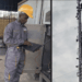 Liberian technician working at cell tower site in Kakata before fatal fall; separate image of tall telecom tower