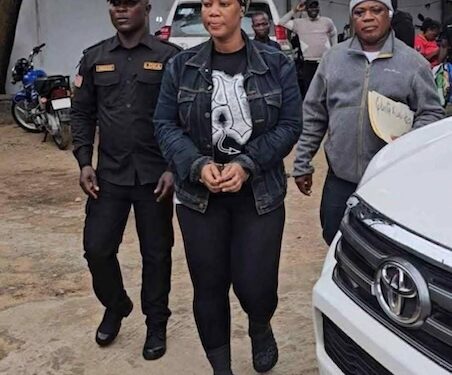 LDEA officers escort Liberian businesswoman Quita Dolo Kosso in handcuffs after her arrest for trafficking US$181K worth of cocaine from Bangkok at Roberts International Airport