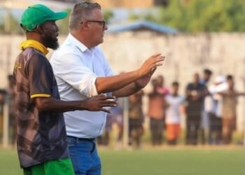 Ivan Minnaert and Matthew Saygba Julutweh on the FC Fassell sidelines during a match in Monrovia, Liberia.